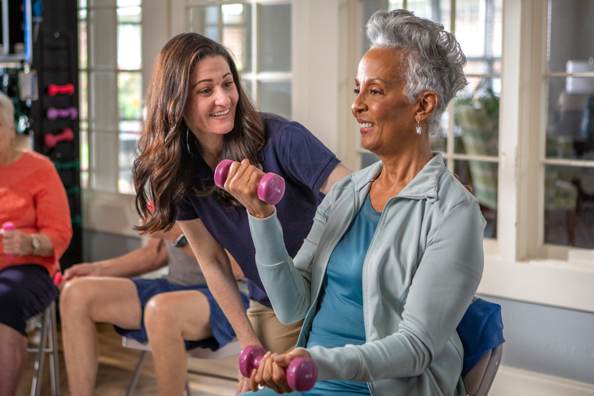Caregiver Exercising With Resident