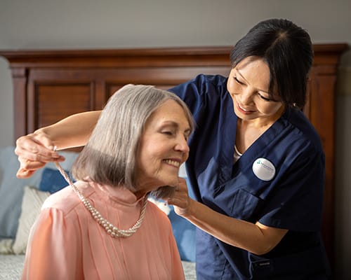 caregiver helping a resident paint