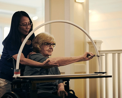 caregiver helping a resident with memory care activity