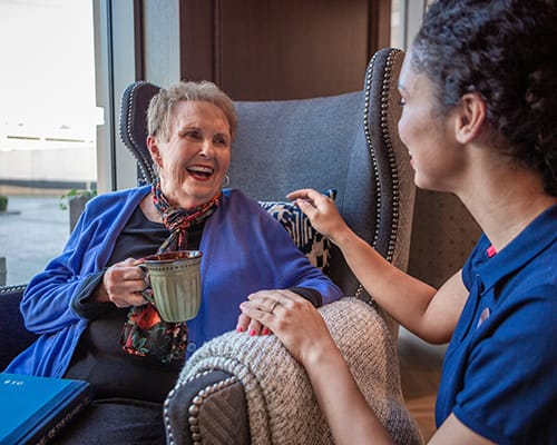 woman laughing with caregiver