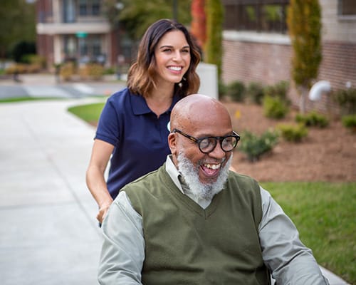 caregiver with man taking photos