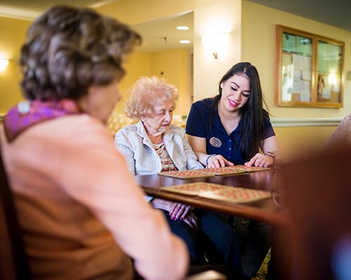 caregiver helping woman play bingo