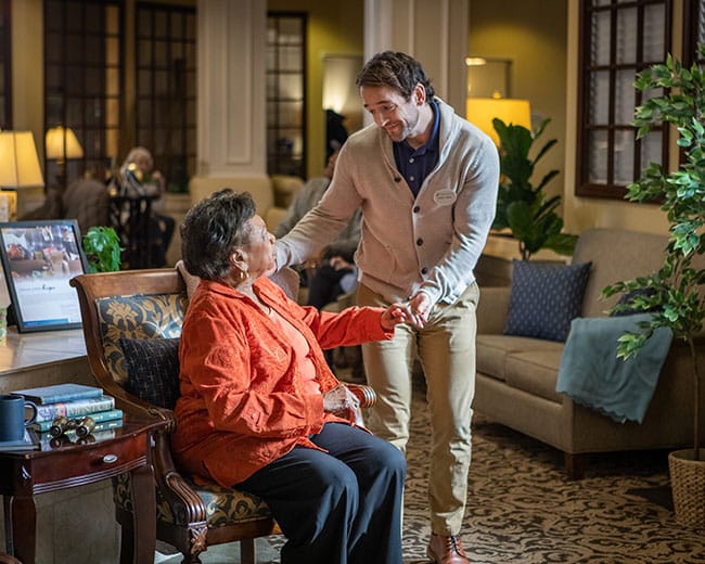 caregiver helping a resident put away groceries