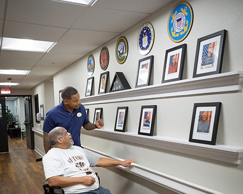 caregiver and man on walking path outside